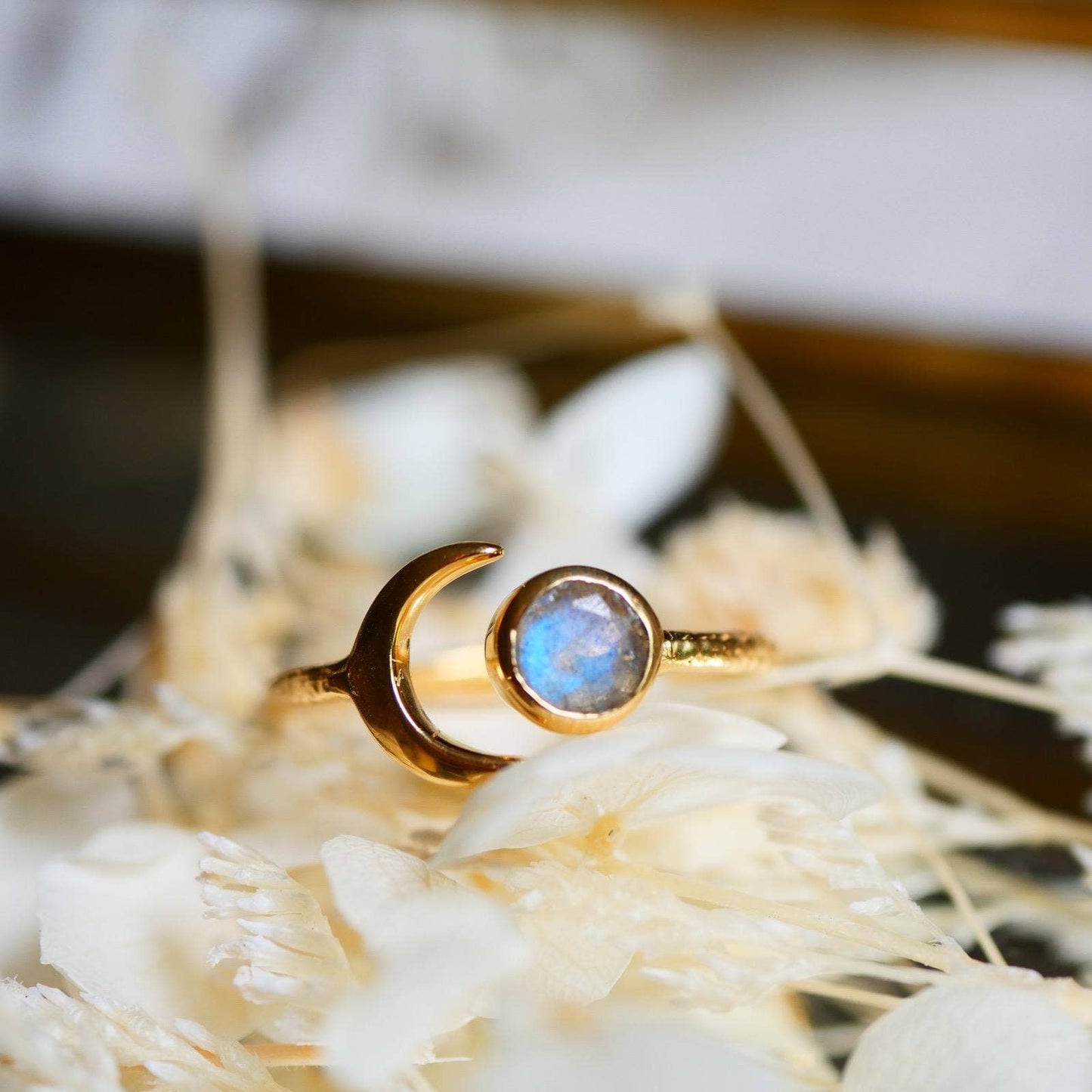 Gold ring with a blue gemstone on a natural background