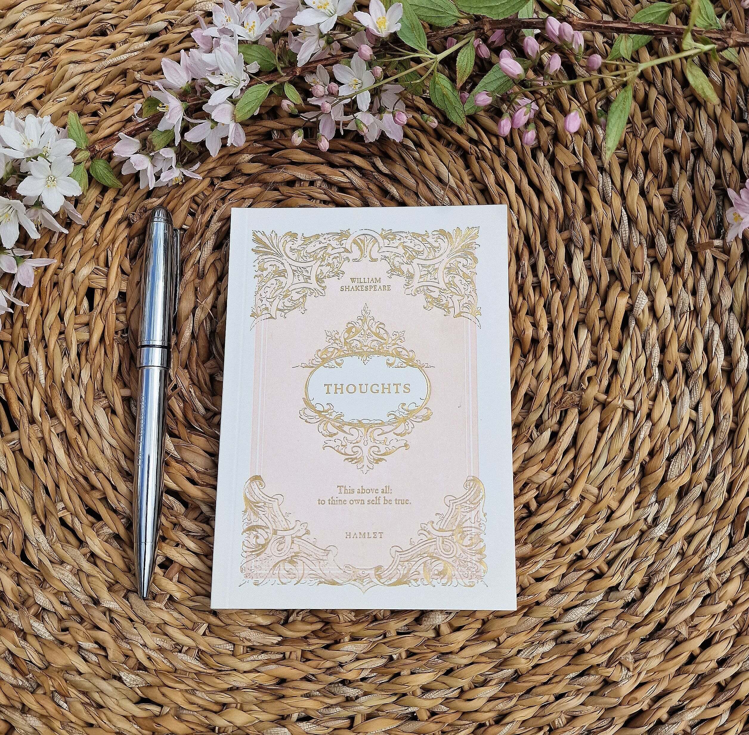 a notepad on a seagrass tray next to a pen