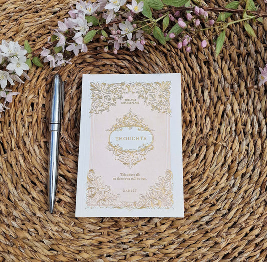 a notepad on a seagrass tray next to a pen