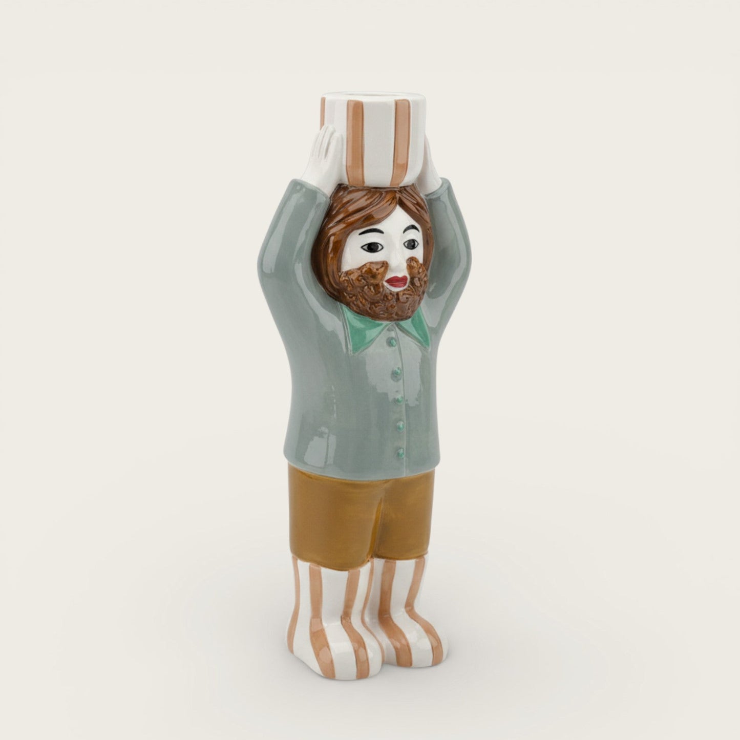 Figurine of a person wearing a chef's hat and striped socks on a white background