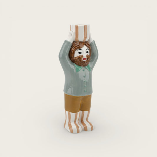 Figurine of a person wearing a chef's hat and striped socks on a white background