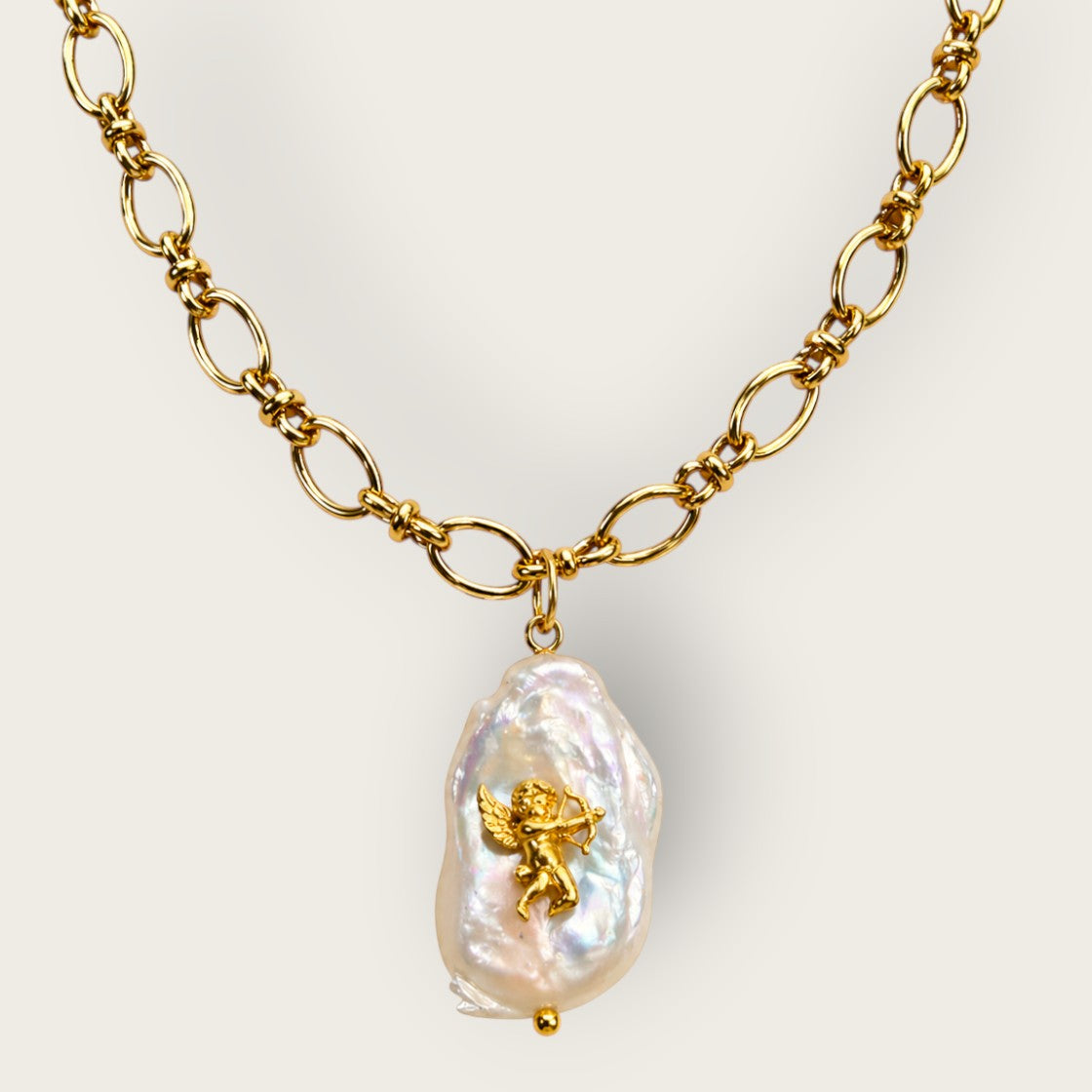 Fable and Mirth ornate gold chain necklace featuring a baroque pearl pendant with a vintage brass angel stamp.