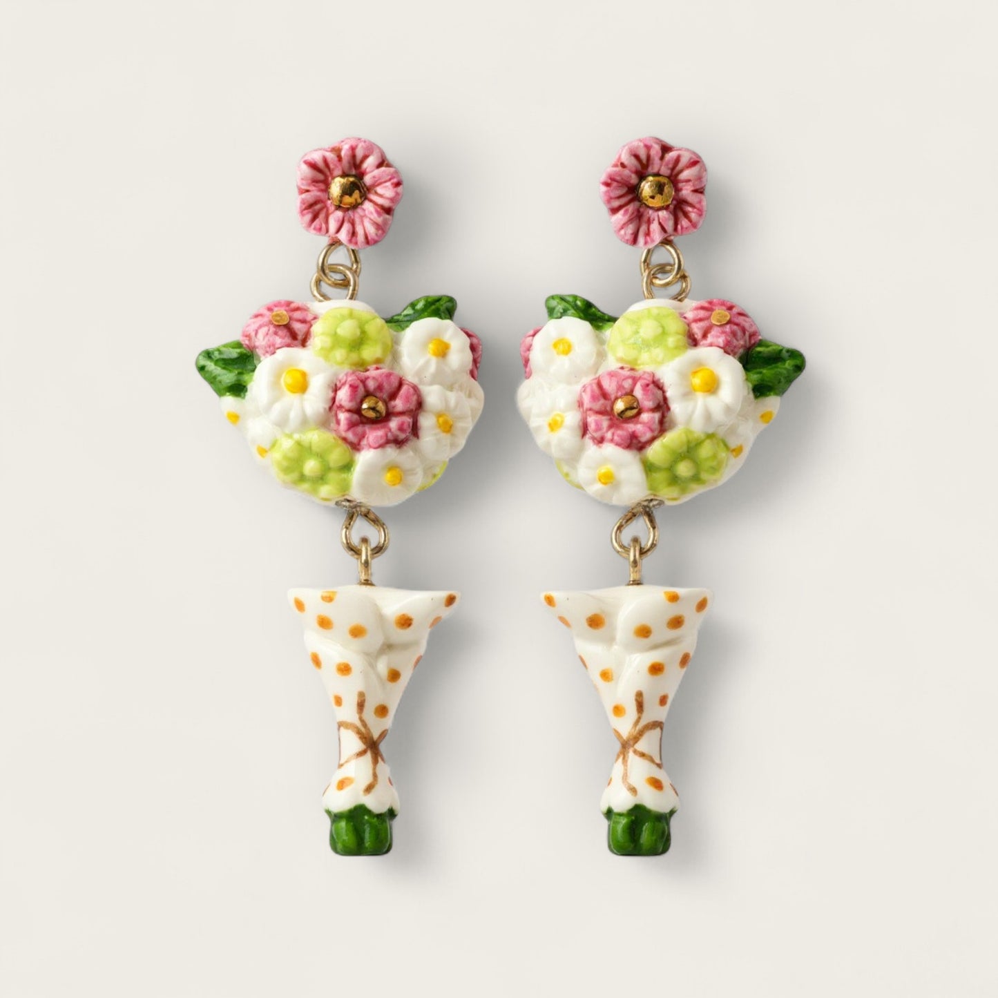 Floral-themed earrings with polka dot bases on a light background